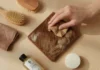 Hair-on-hide cowhide wallet with natural grain texture placed on wooden table