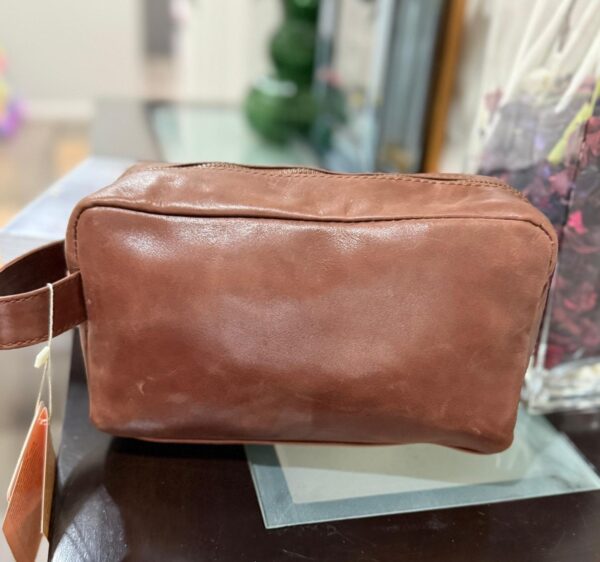 Leather toiletry bag with waterproof lining and interior pockets
